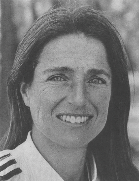 black and white photo portrait of white woman with hair down smiling at camera