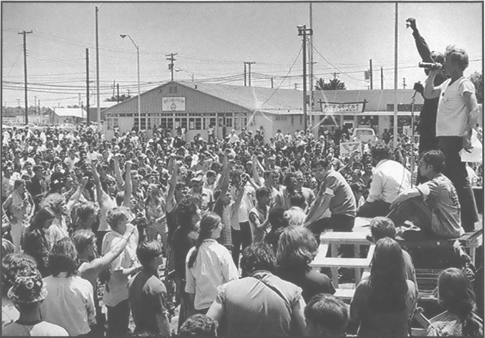 Rally with speaker on stage raising fist