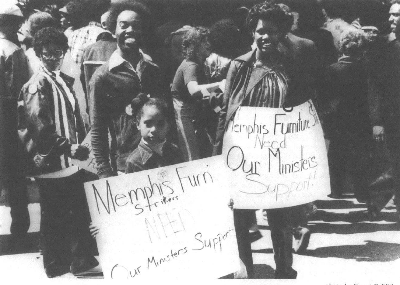 Black and white photo of group of demonstrators holding signs