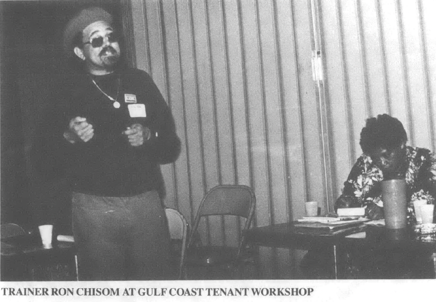 Photo of Black man in cap and sunglasses standing with mic speaking, Black woman at a table in the background. Caption reads TrainerRon Chisom at Gulf Coast tenant workshop