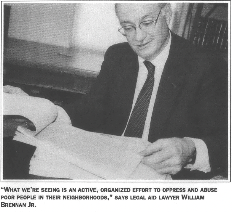 Older man in suit and tie reading documents 