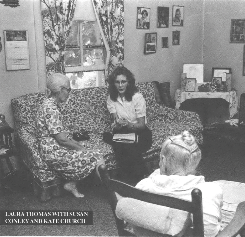 Photo of two women, one older and one younger, sitting on couch in living room 