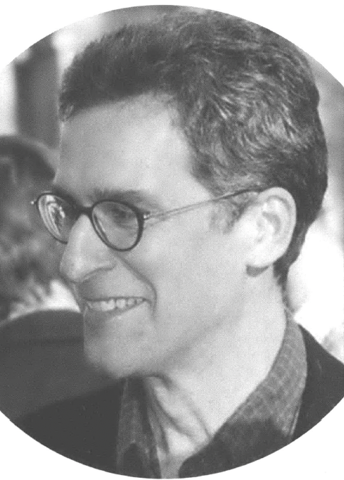 Side profile portrait of smiling man in glasses