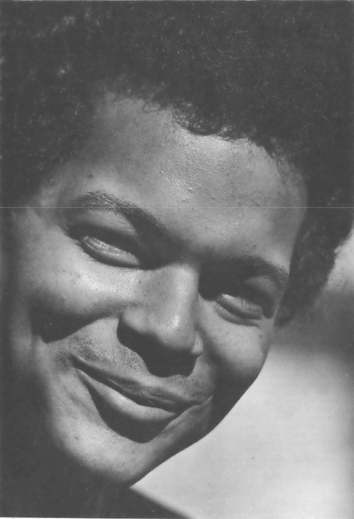 Black and white close-up photo of a young Black man, Julian Bond