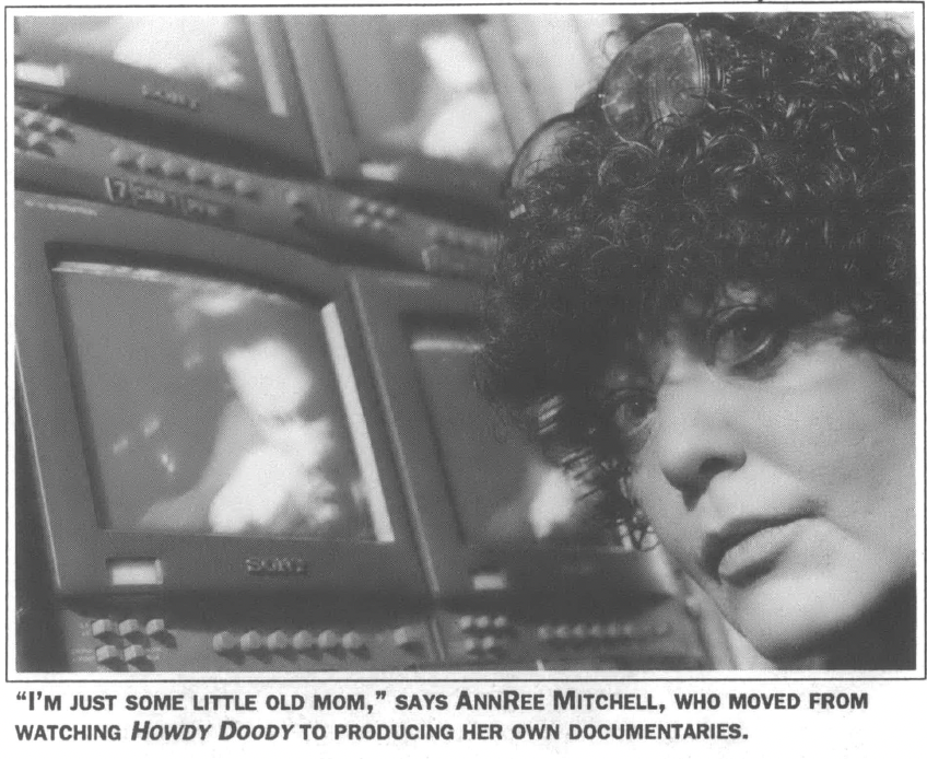 Woman's face in front of many televation sets