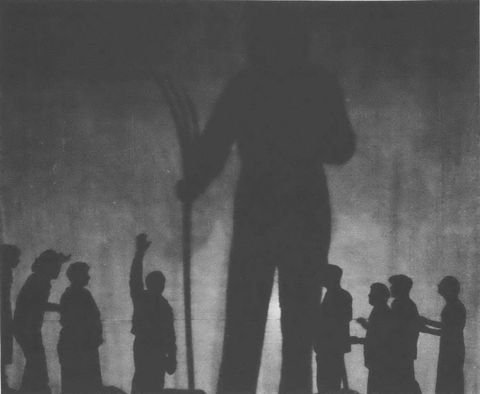 Black silhouette of a large person holding a pitchfork in the center, with eight smaller human silhouettes in various poses