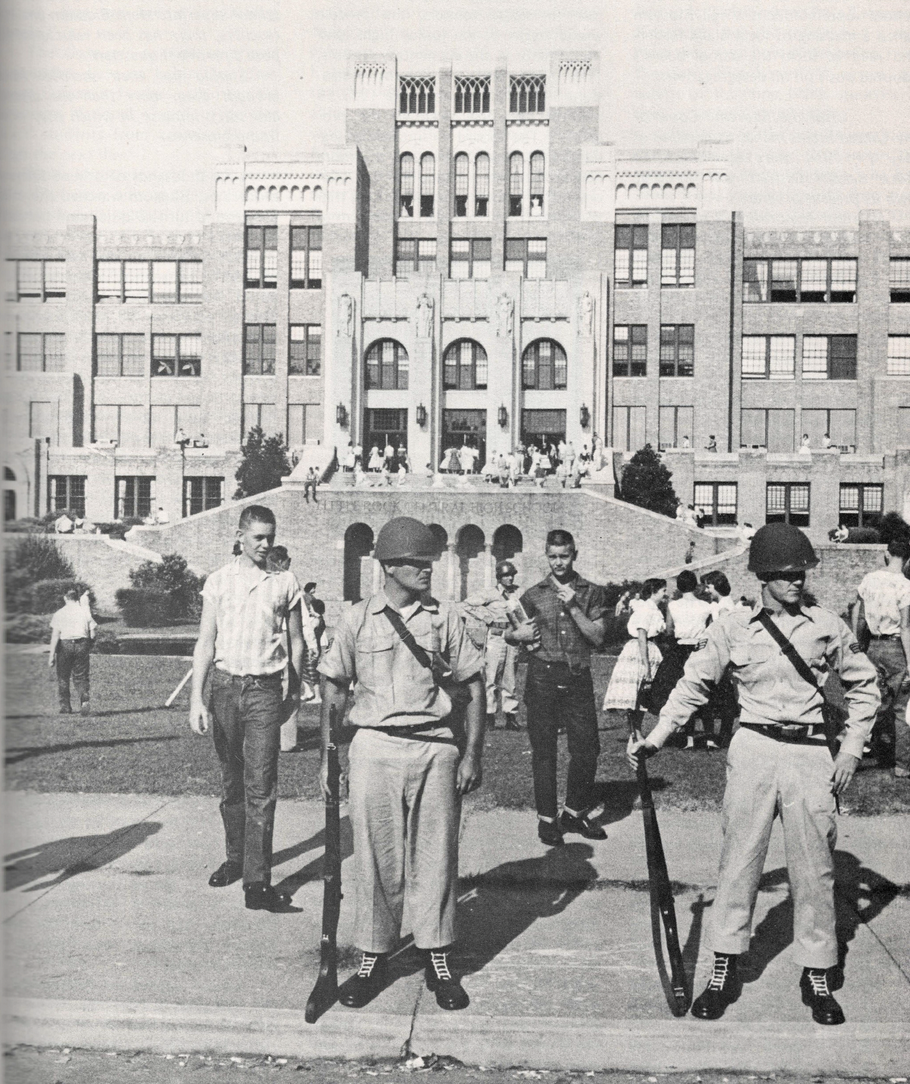 Black and white photo of National Guard and white students standing in front of Little Rock Central high school