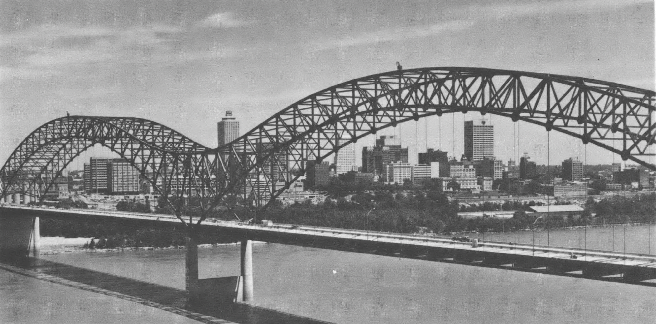 Black and white photo of large bridge over river