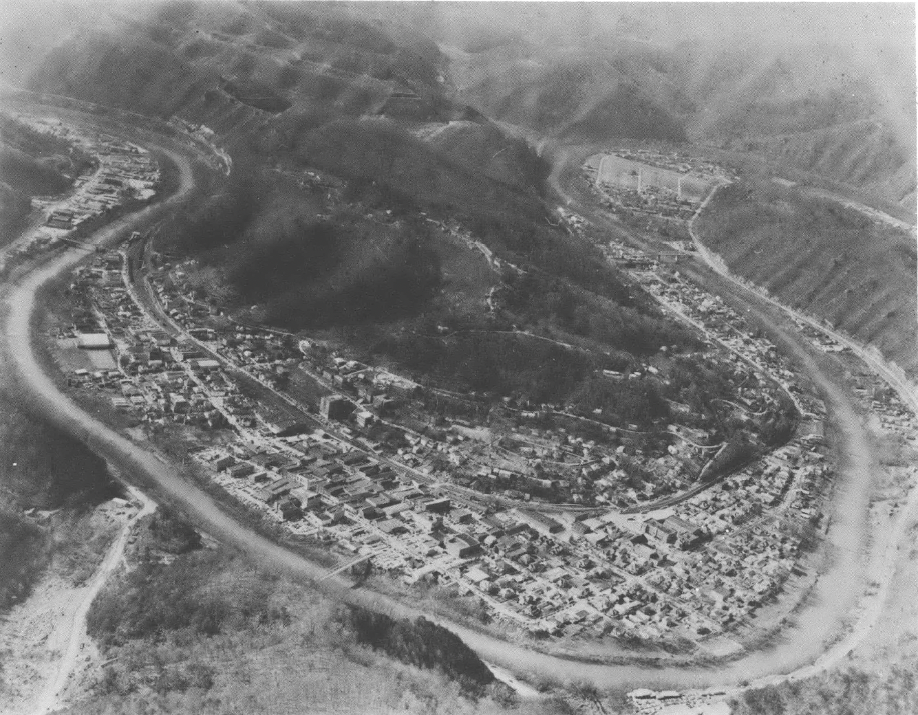 Black and white aerial view of some homes and small town 