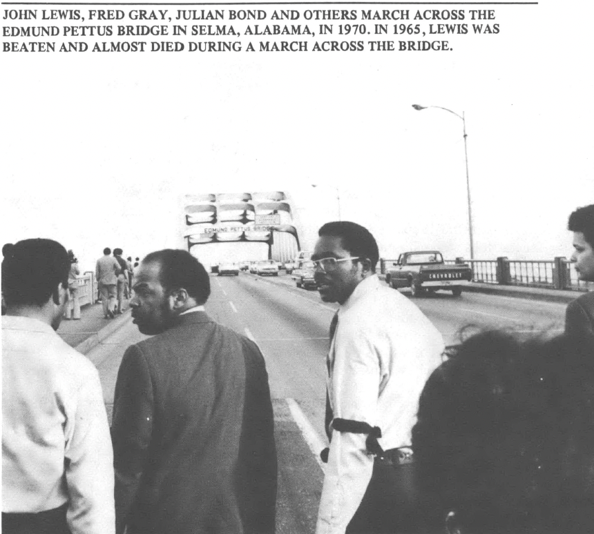 Black and white photo of John Lewis and others crossing the Edmund Pettus bridge