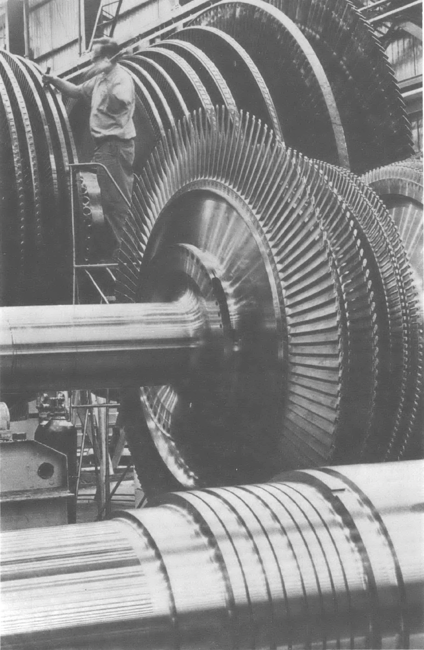 Black and white photo of large machinery inside building 