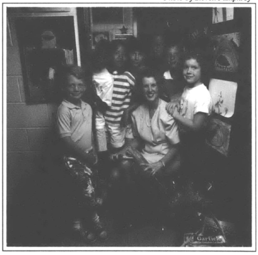 photograph of teacher and students