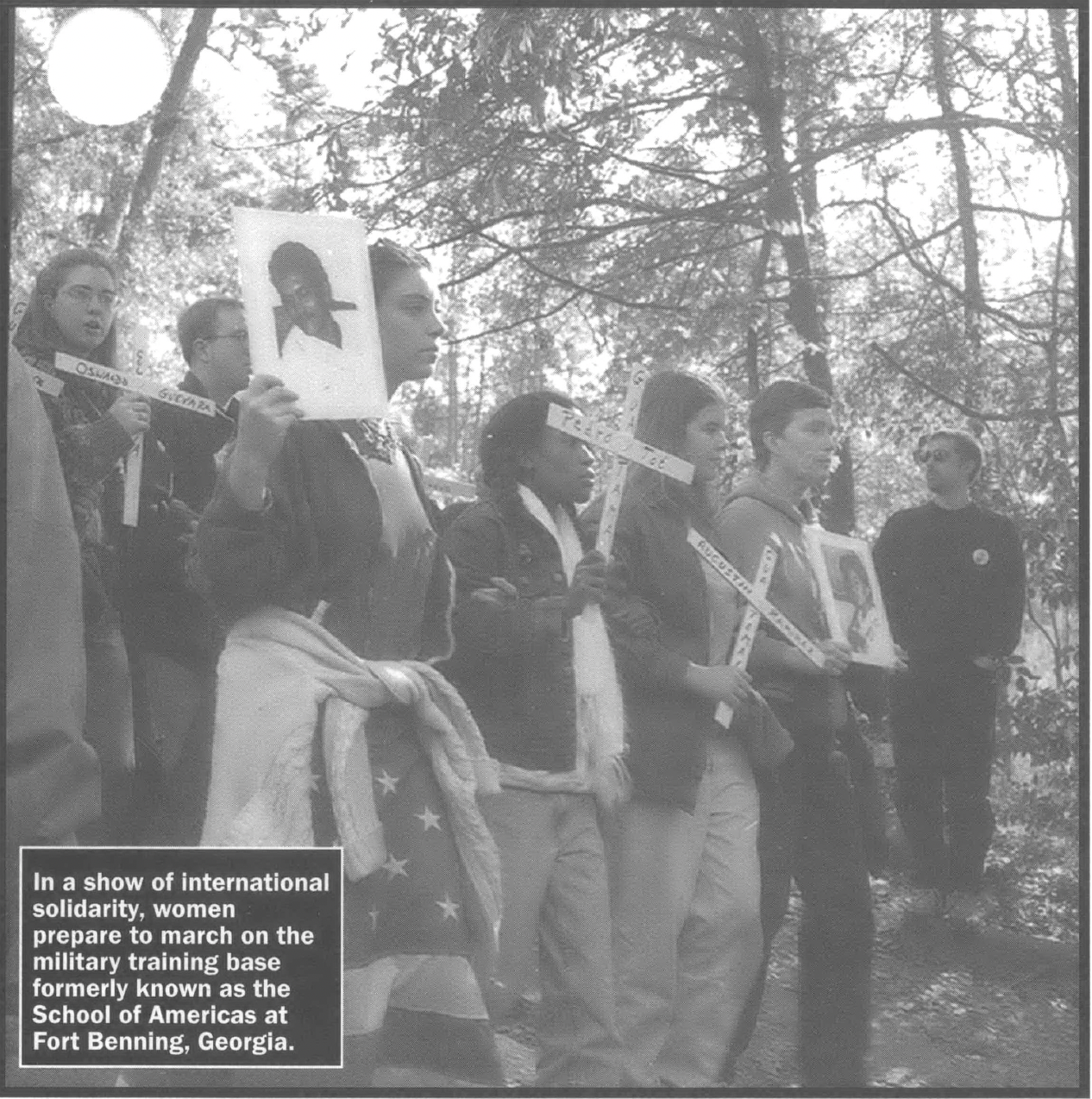 In a show of international solidarity, women prepare to march on the military training base formerly known as the School of Americas at Fort Benning, Georgia.