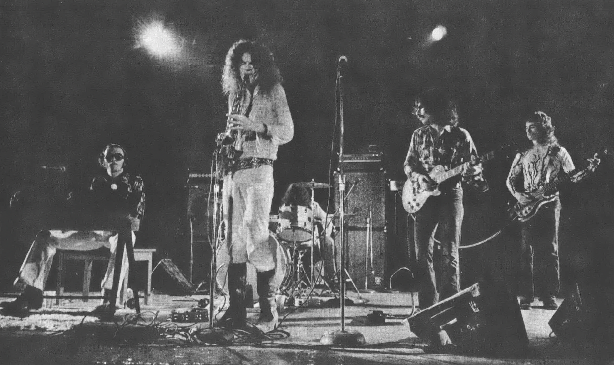 Black and white photo of rock band on stage