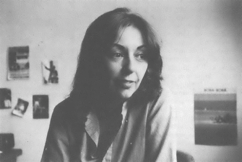 Black and white portrait of young white woman with long hair looking away from the camera