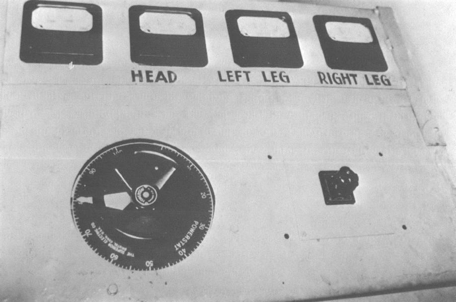 Black and white photo of machine with buttons reading"head," "left leg," "right leg"