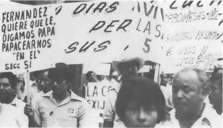 Black and white photo of people with signs, many in Spanish