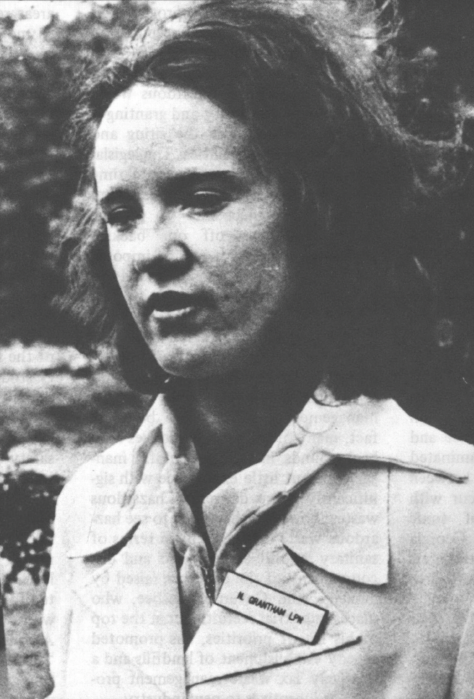 Black and white photo of young white woman in some kind of uniform talking