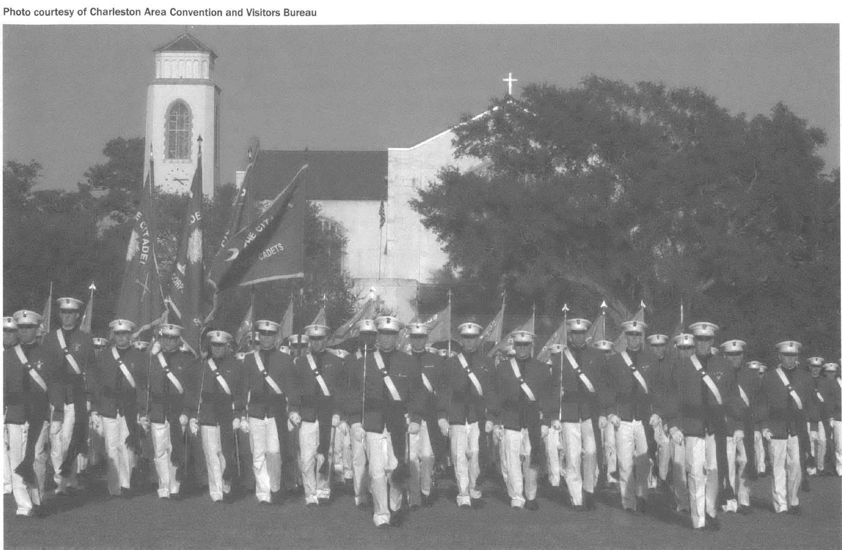 Rows of students in military uniforms in front of university building