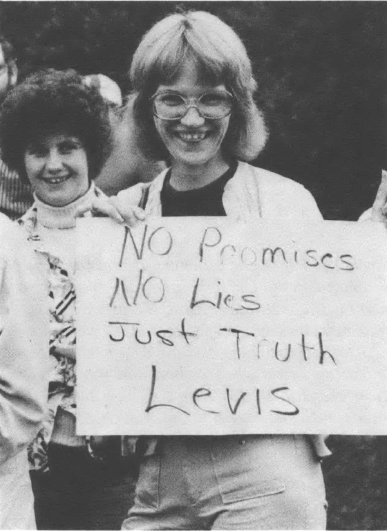Black and white photo of young woman holding side reading "No Promises No Lies Just Truth Levis"