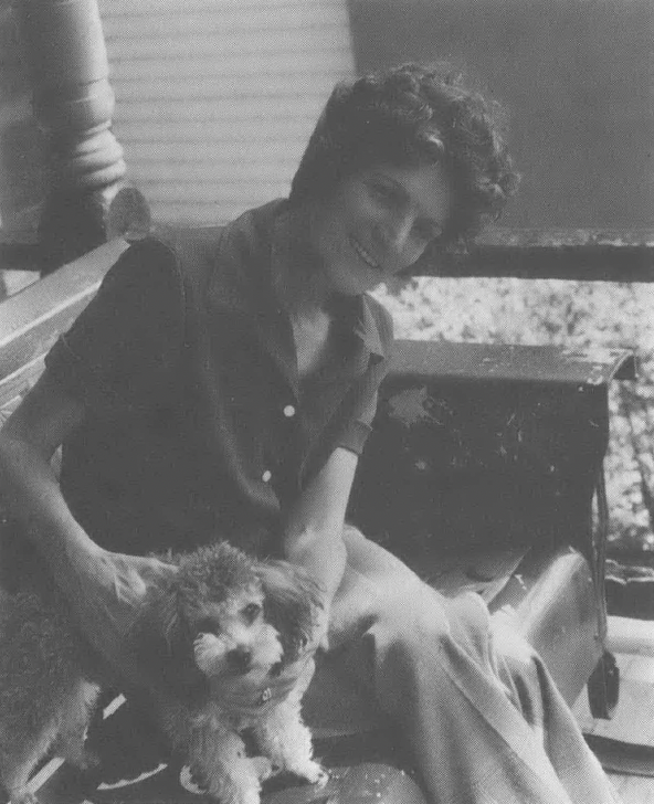 Black and white photo of person with small dog 
