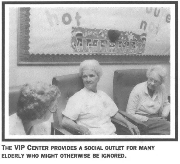 Three elderly women seated and talking