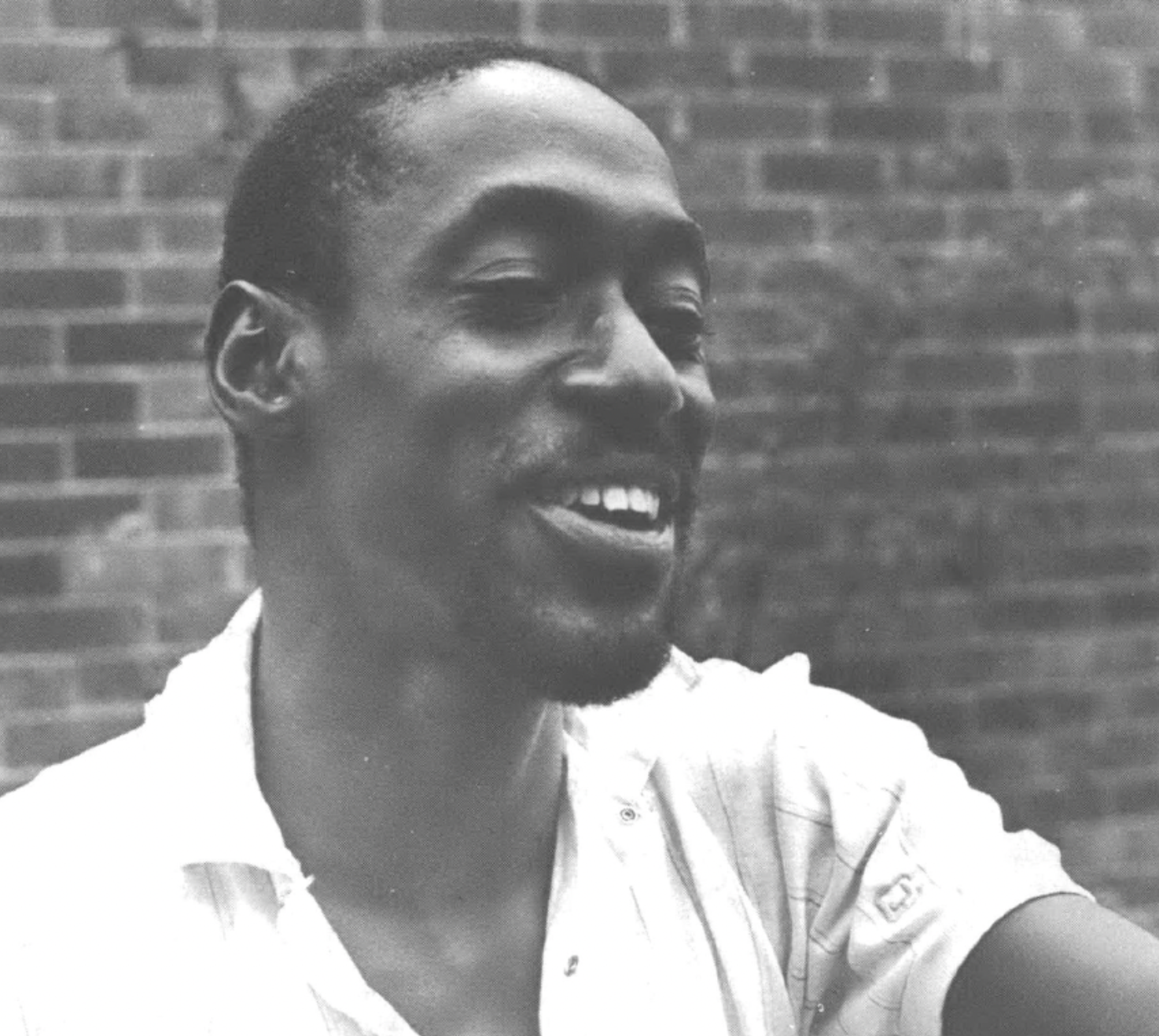 Headshot photo of Black man laughing