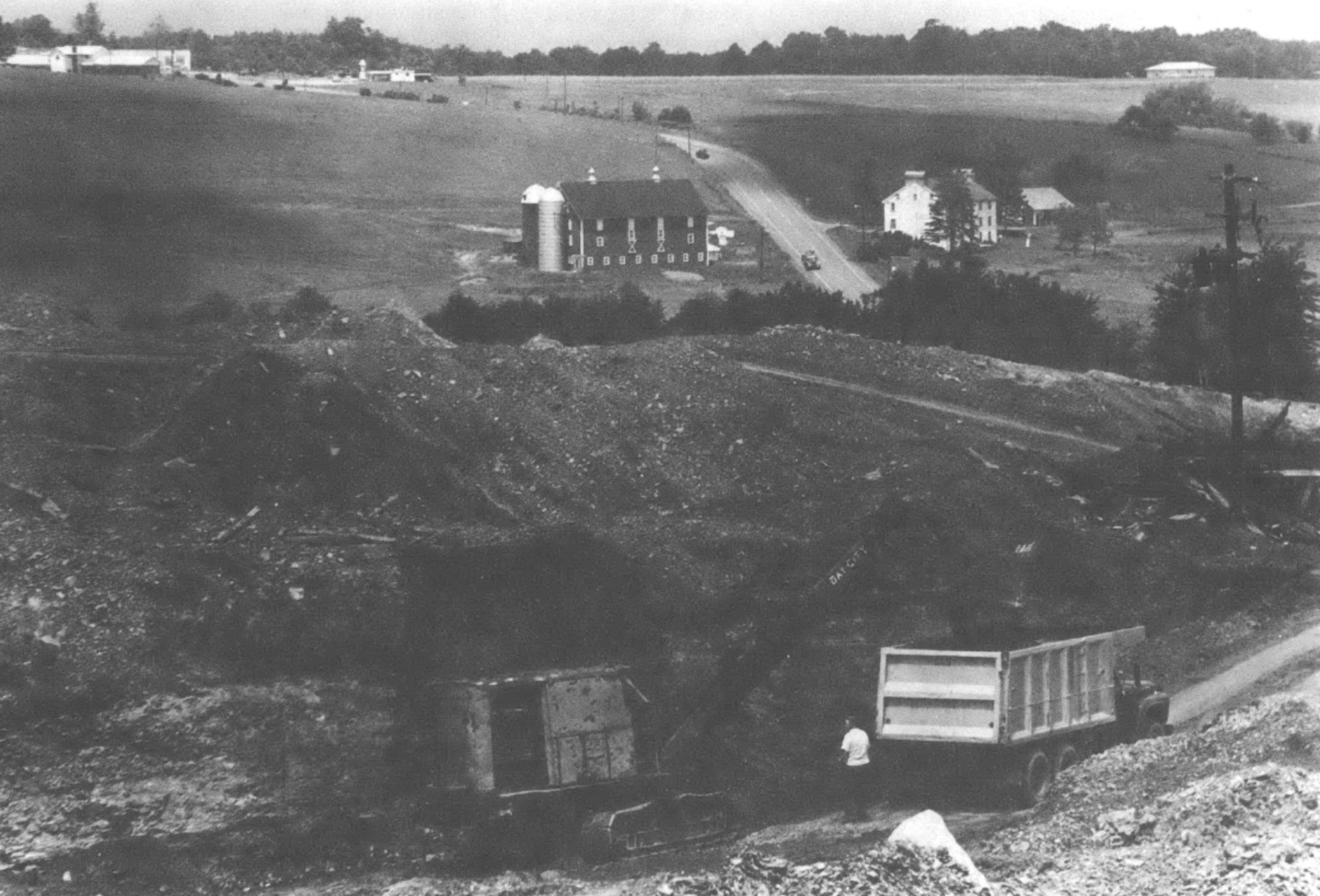 Land in the mountains with machinery in the foreground