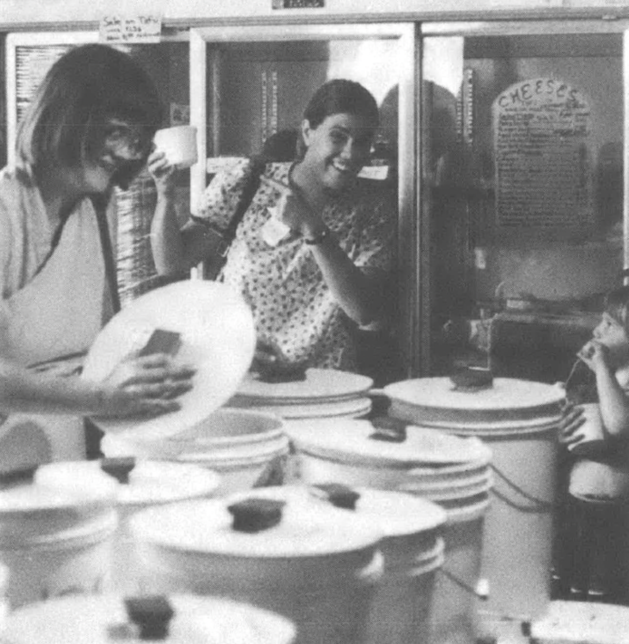 two women smiling and opening buckets