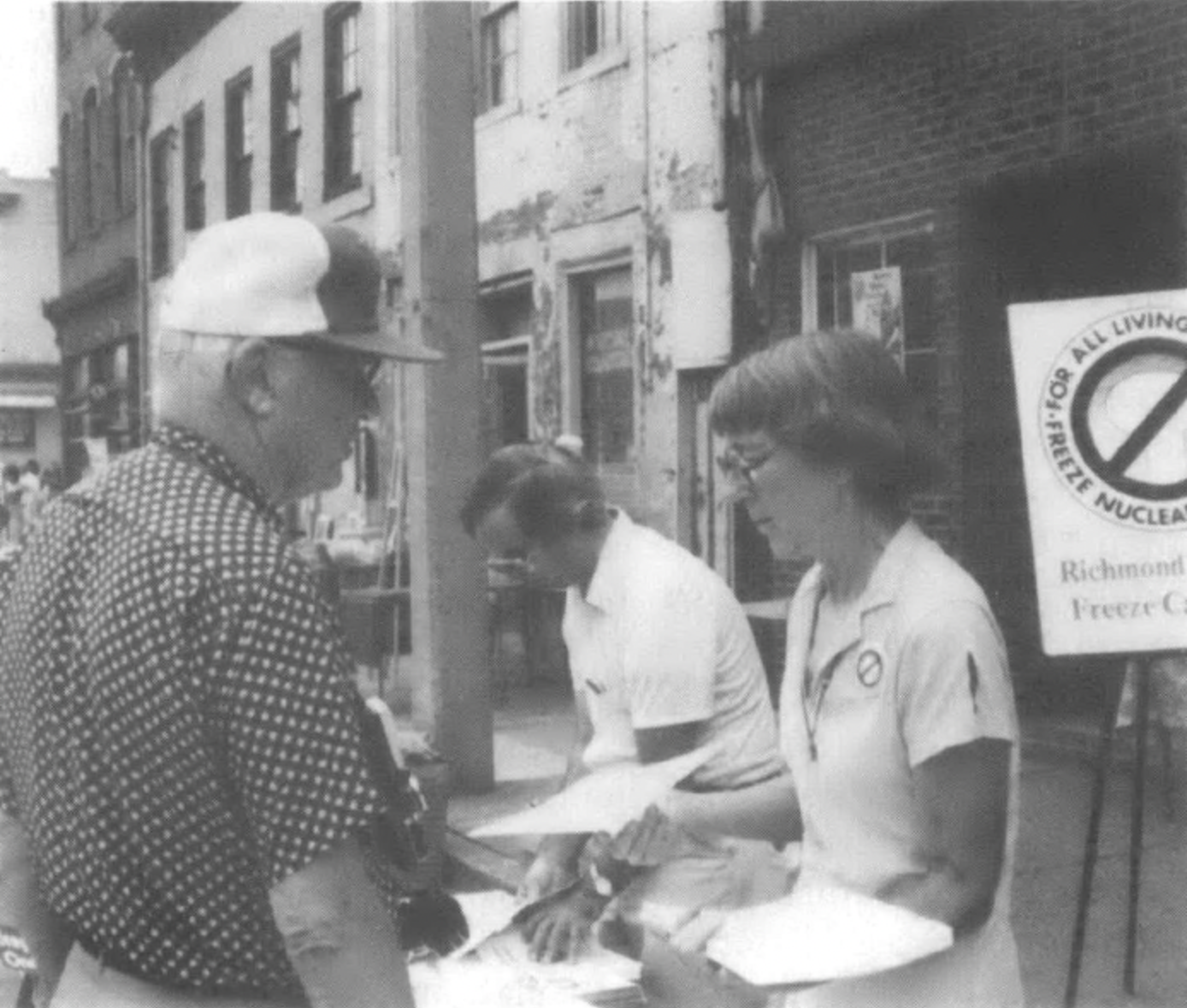 Phyllis Conklin handing paper out to man