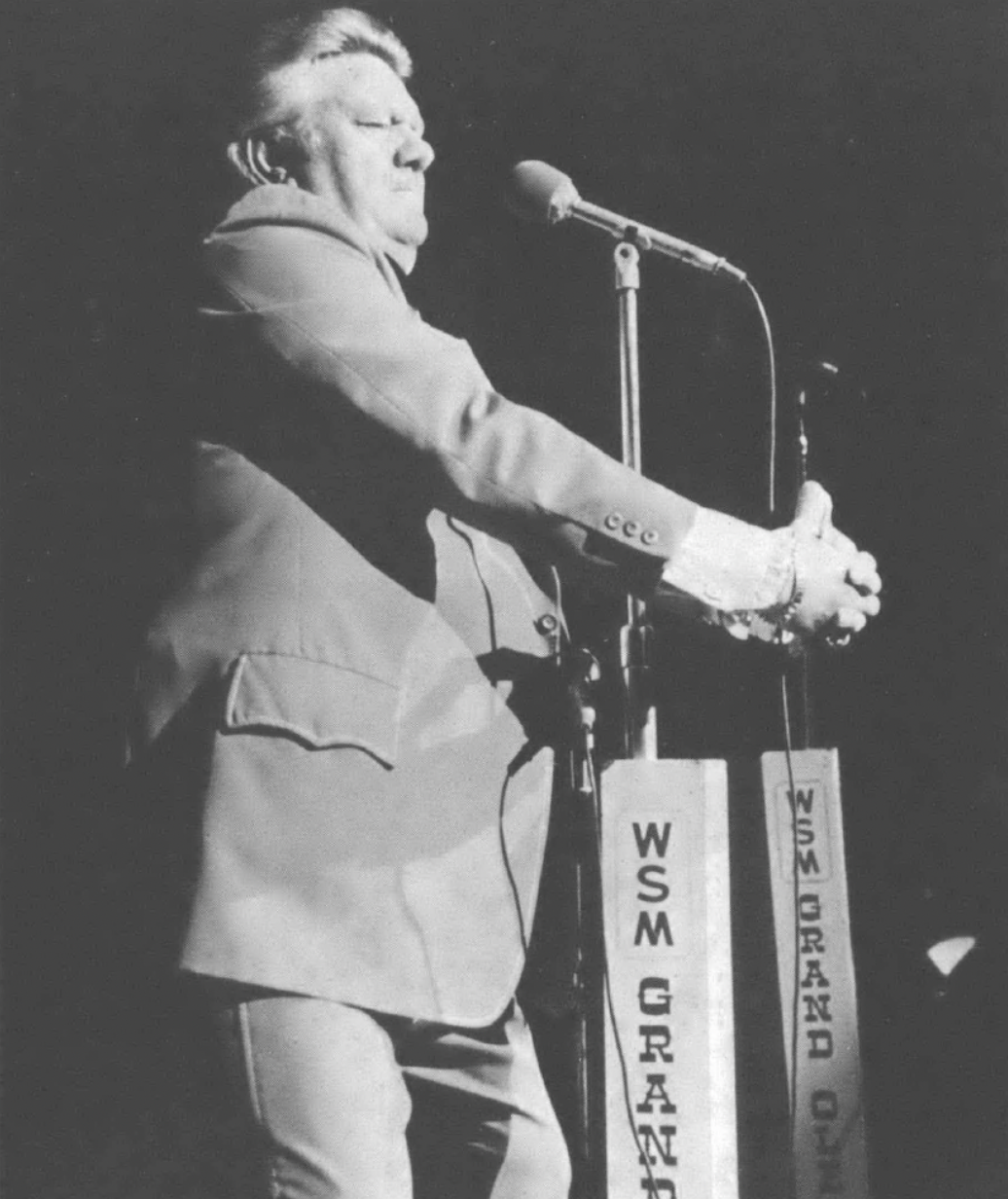 man hugging a microphone