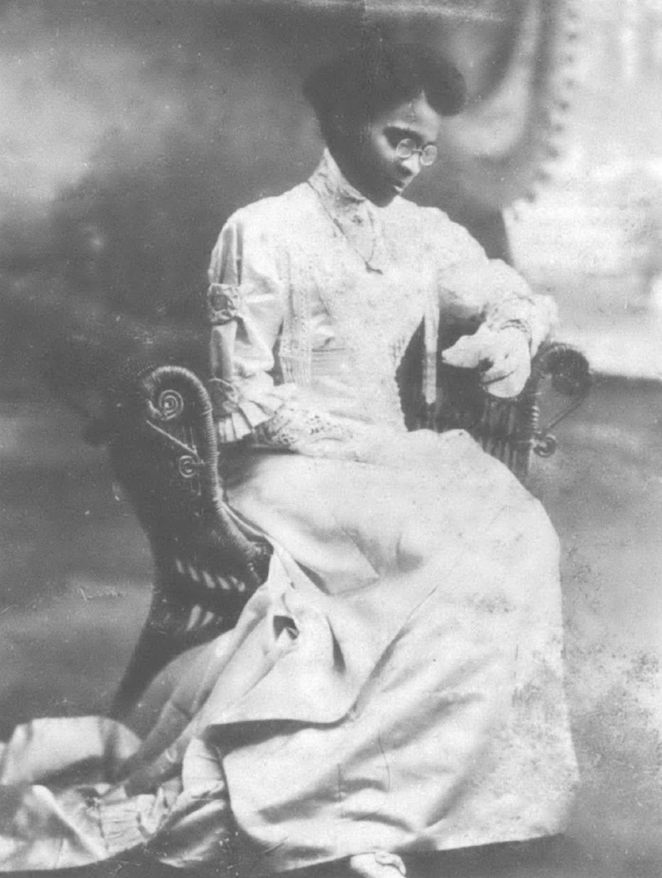 portrait of Black woman sitting in chair looking down