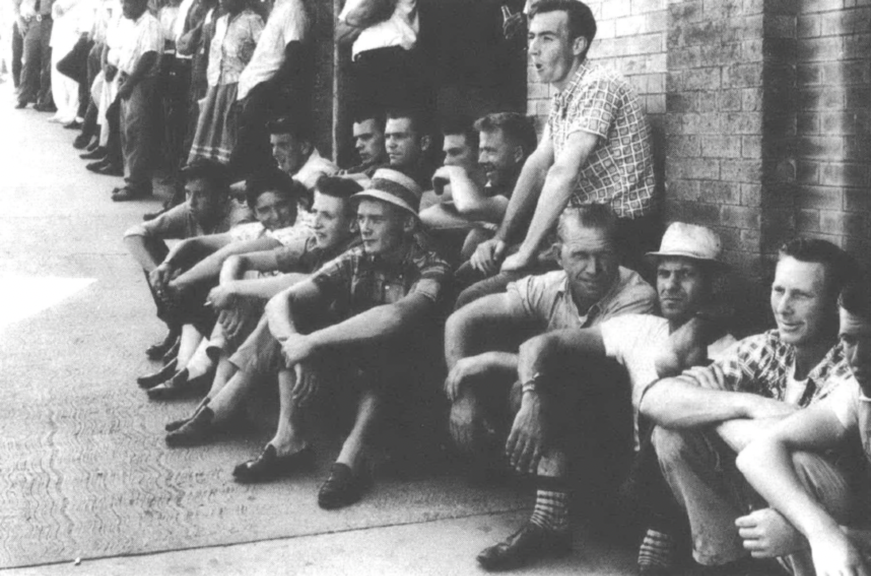 men sitting and lined up