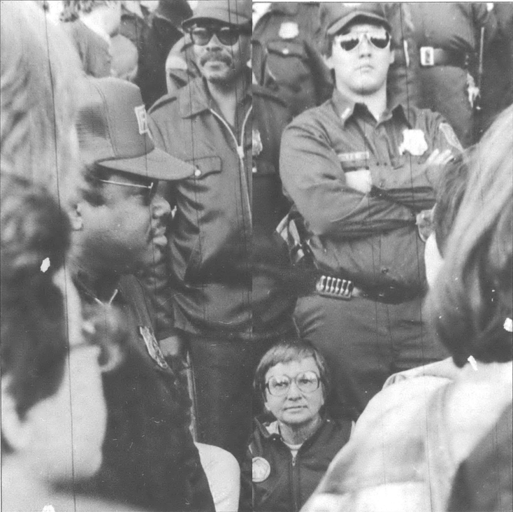 Women's Pentagon Action, 1981 - Police officers standing above a woman