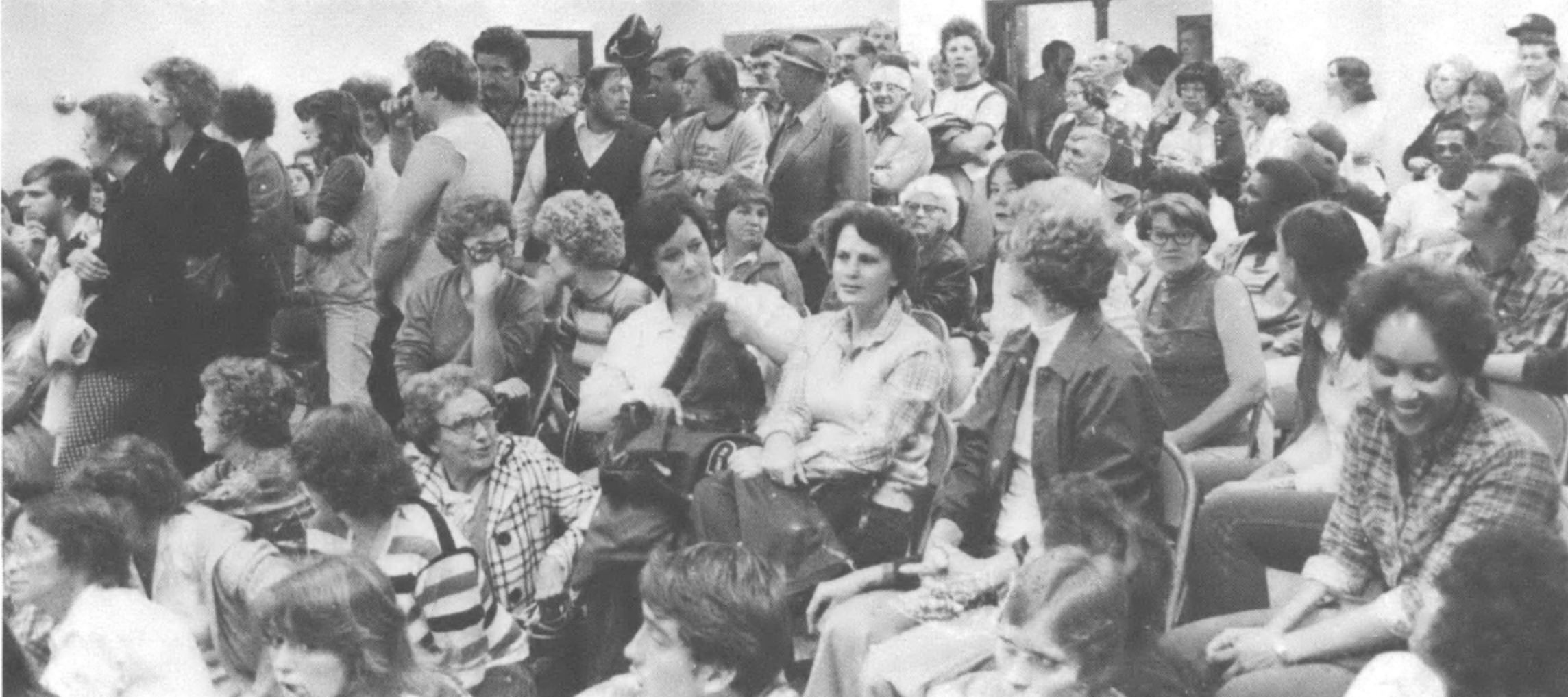 people sitting in a room - black and white