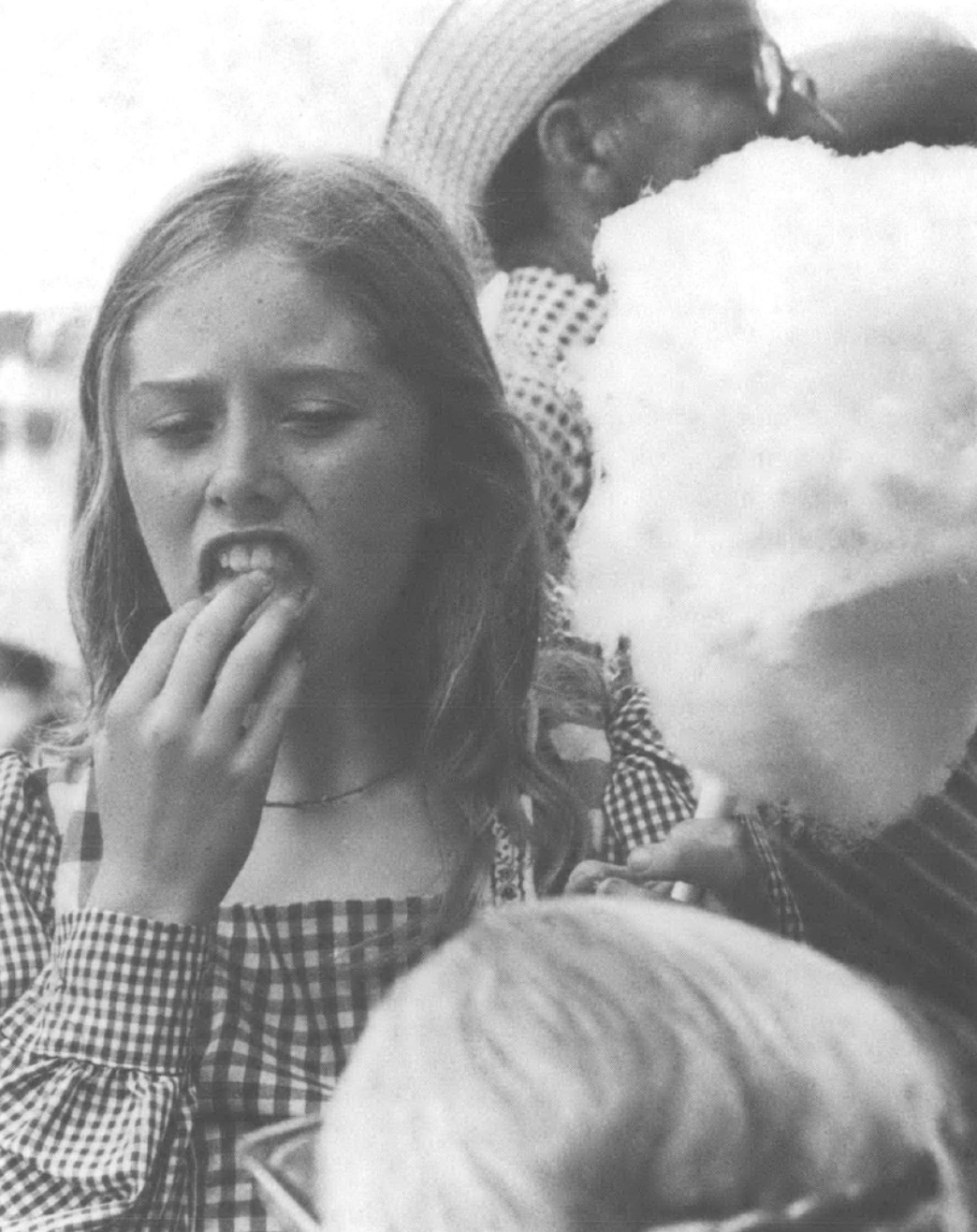 a girl eating cotton candy