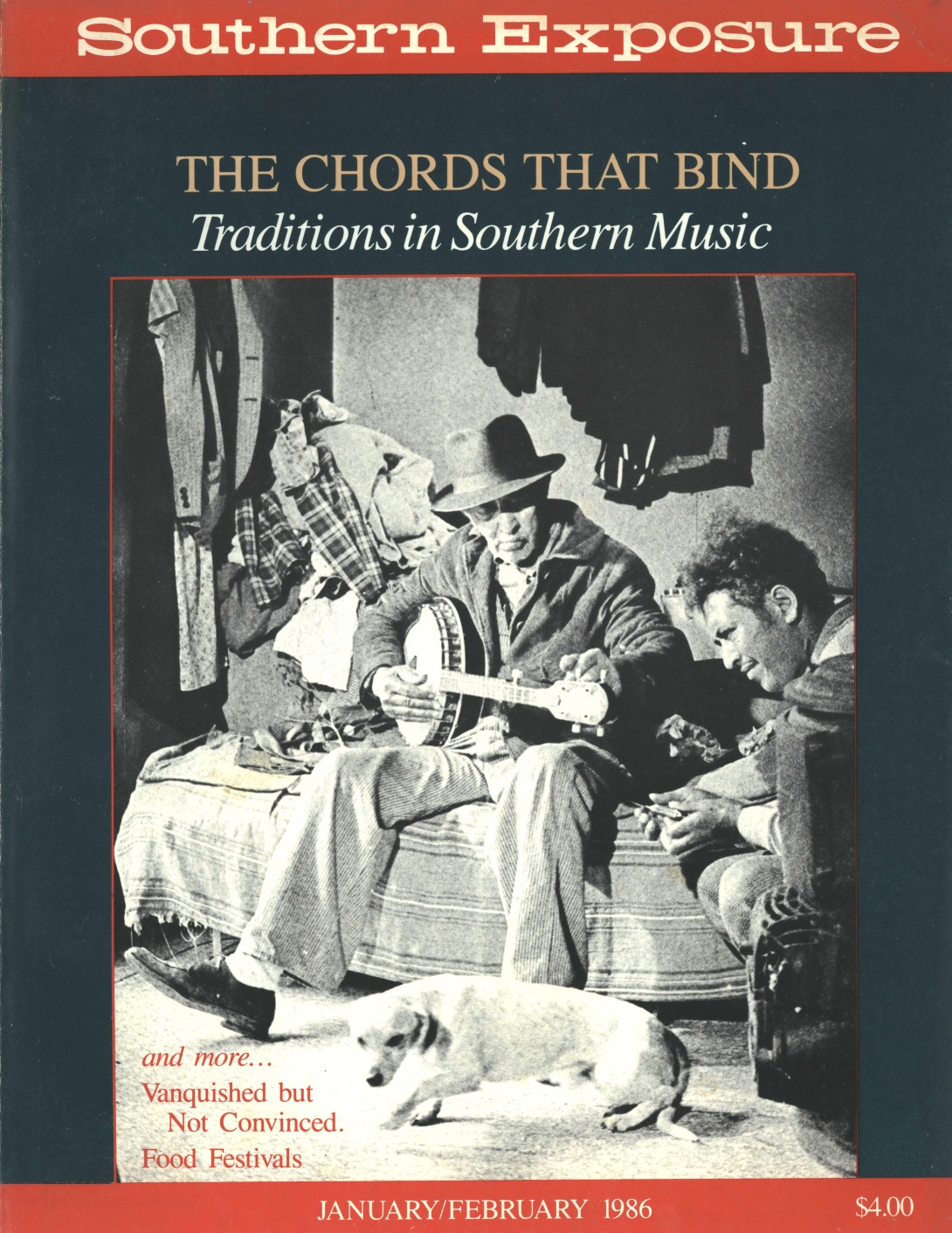 Magazine cover with photo of two men playing string instruments and dog 